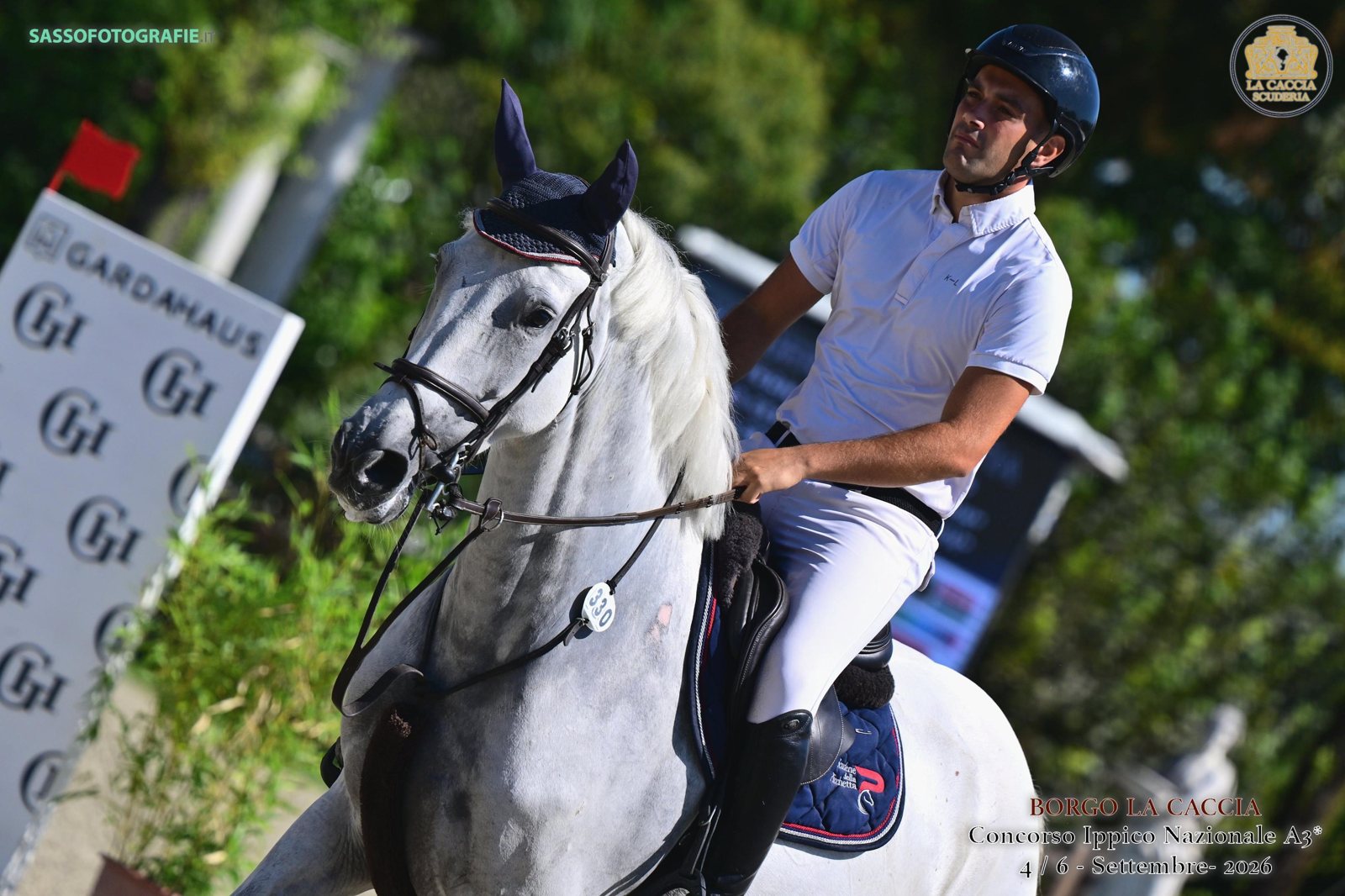 Grey mare and rider head on after a round, showing her expression